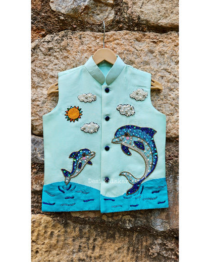 "Three-piece boys' festive outfit featuring a sea green hand-embroidered dolphin jacket layered over a matching textured zig-zag kurta and classic white pants."