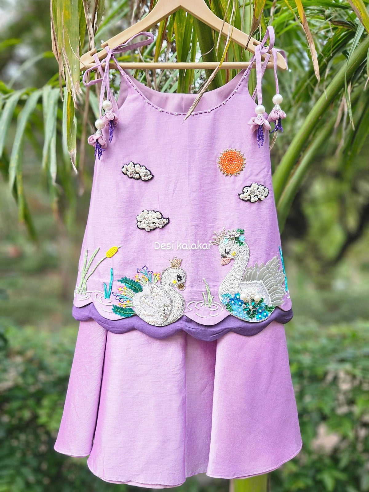 Lavender handcrafted zardozi embroidered swan motif A-line top and flared pants set with pearl tassels for girls by Desi Kalakar.
