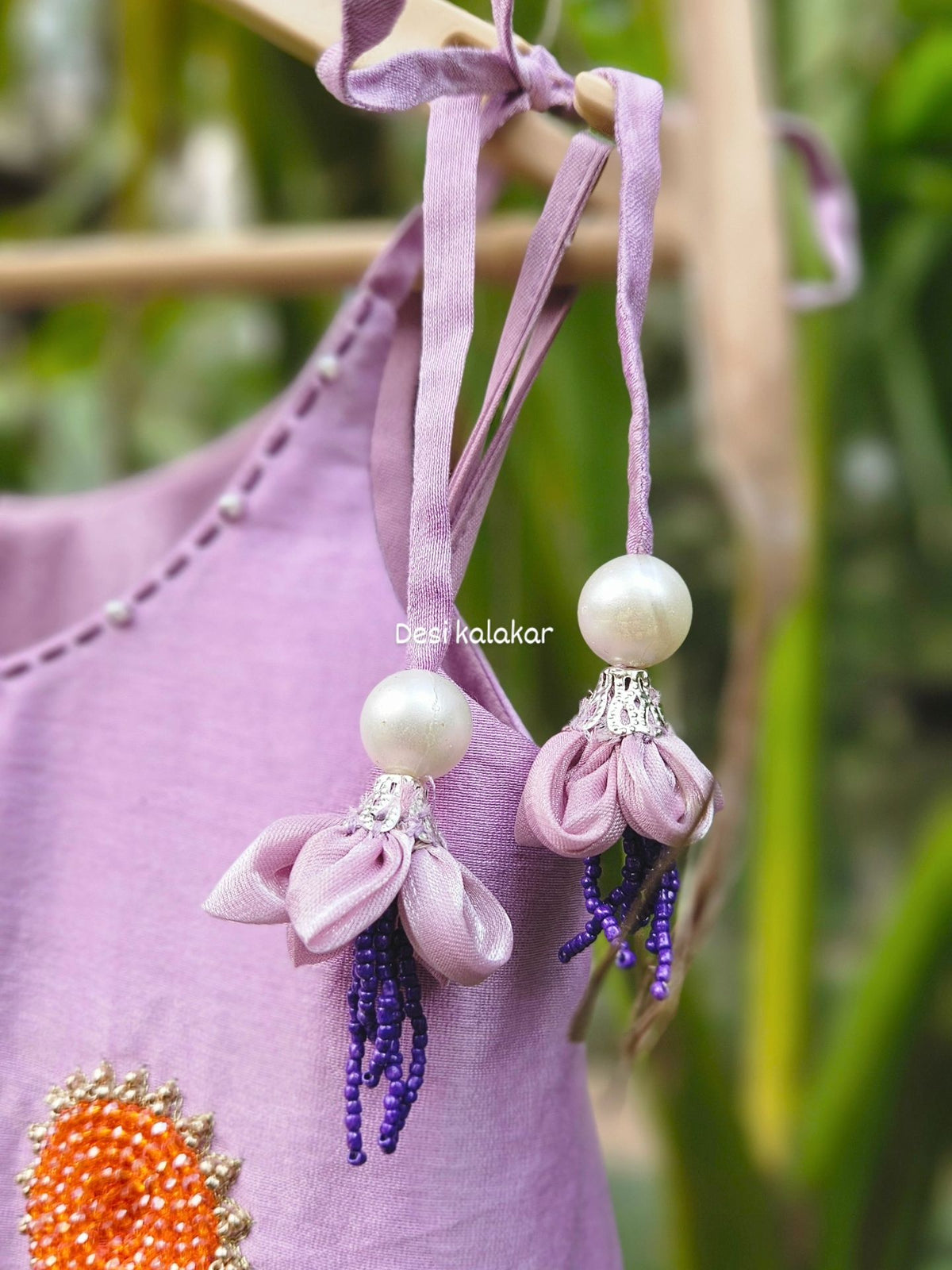 Lavender handcrafted zardozi embroidered swan motif A-line top and flared pants set with pearl tassels for girls by Desi Kalakar.