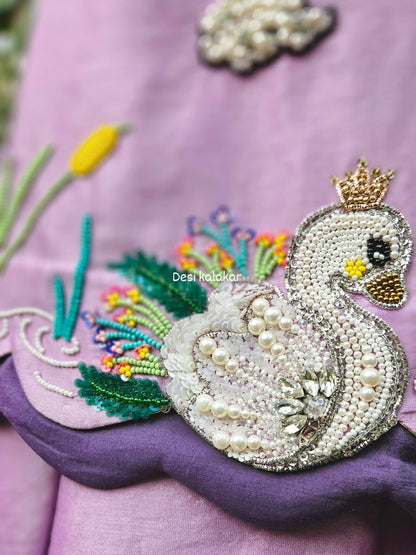 Lavender handcrafted zardozi embroidered swan motif A-line top and flared pants set with pearl tassels for girls by Desi Kalakar.