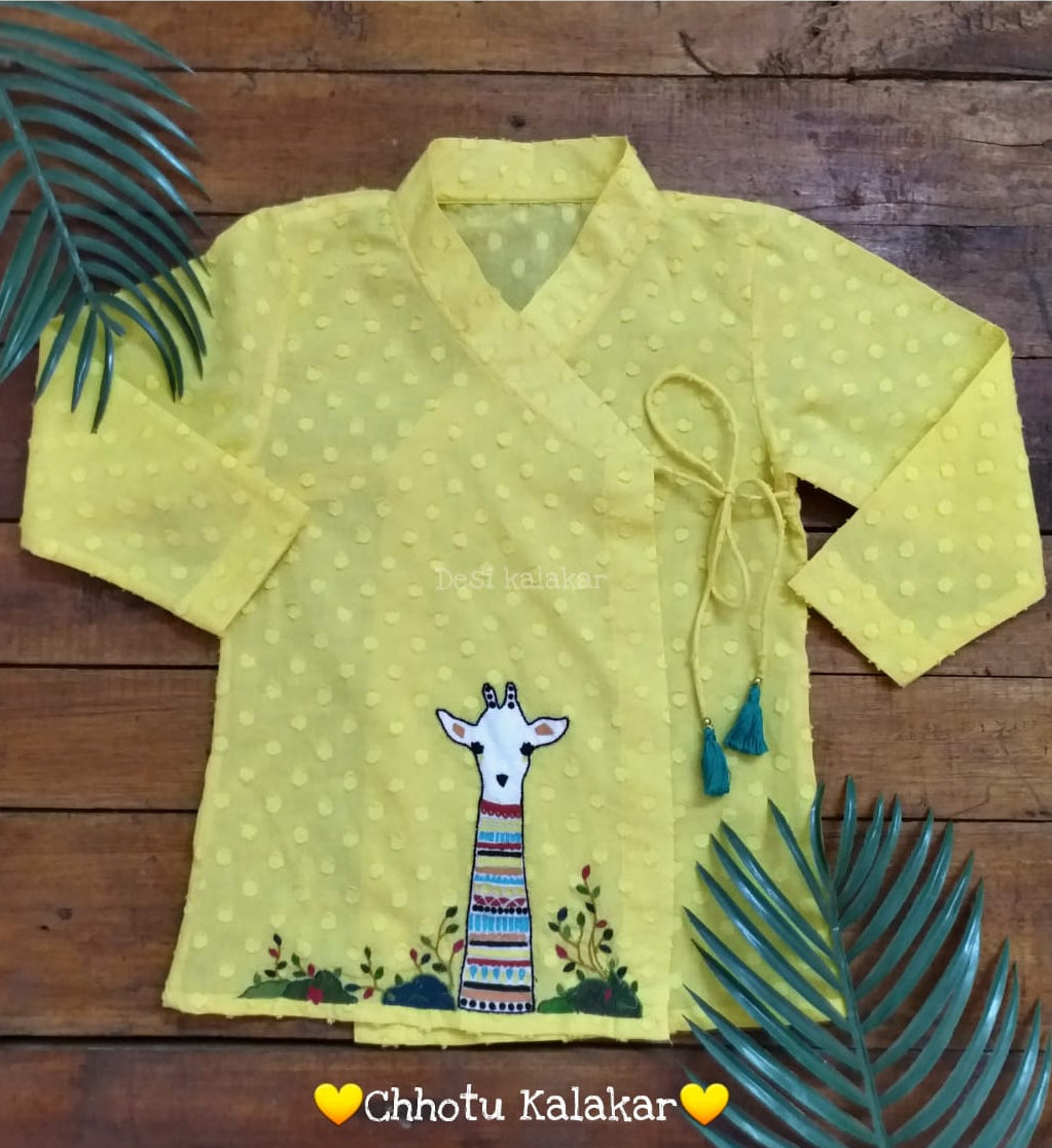 Baby boy wearing sunshine yellow cotton angrakha kurta with hand embroidered giraffe motif and off-white dhoti
