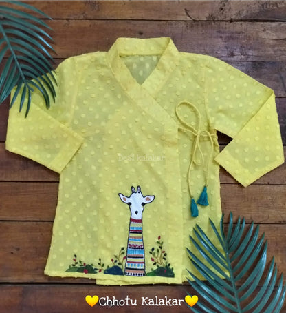Baby boy wearing sunshine yellow cotton angrakha kurta with hand embroidered giraffe motif and off-white dhoti
