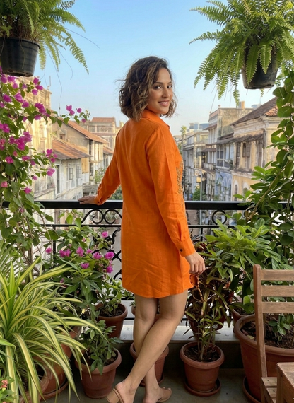 Woman in an orange dress standing 